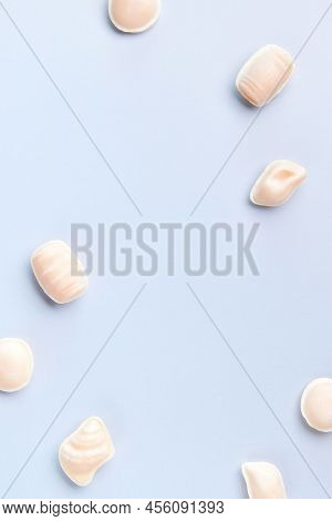 Flat Lay Top View Of Traditional Portuguese Egg Yolk Sweets Ovos Moles De Aveiro On Blue Background.