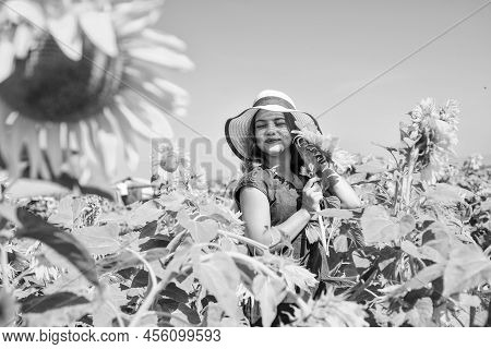 Beautiful Girl Wear Straw Summer Hat In Field. Pretty Kid With Flower. Beauty Of Summer Nature. Litt