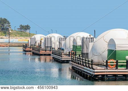 Pohang, South Korea; May 6, 2022: Round Fishing Cabins Anchored To Docks At Rural Fishing Port.