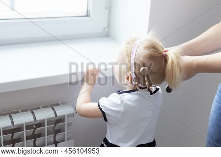 Mother Fixing Her Daughters Cochlear Implant Hearing Aid - Deafness And Diversity Concept. Innovativ