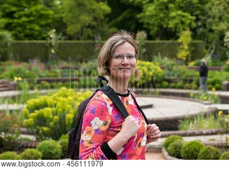 Portrait Of An Attractive Thirty Year Old Woman With Colorful Clothes And A Nature Park Background, 