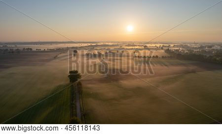 Aerial Drone Shot Of A Beautiful Green And Yellow Agricultural Plantations Bordering With Wild Fores