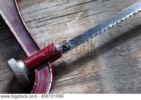 Detail Photography Of The Teeth Of A Saw, Wooden Background