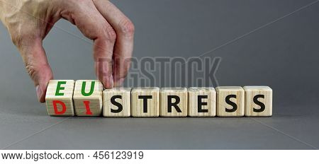 Eustress Or Distress Symbol. Psychologist Turns Cubes And Changes The Concept Word Eustress To Distr
