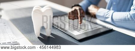 E Signing Dentist Insurance Contract On Tablet Computer