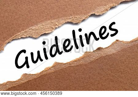 Guidelines Concept. Text On Torn Brown Paper. View From Above
