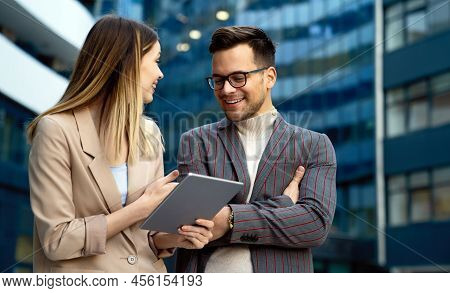 Two Desingers, Business People Working On A Project Together In Urban Background