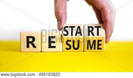 Restart And Resume Symbol. Businessman Hand Turns Cubes And Changes The Word 'recovery' To 'resume'.