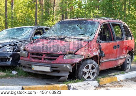 Shot, Damaged Cars During The War In Ukraine. The Vehicle Of Civilians Affected By The Hands Of The