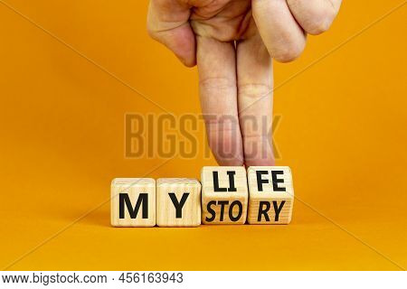 Story Of My Life Symbol. Businessman Turns Wooden Cubes And Changes Concept Words My Story To My Lif