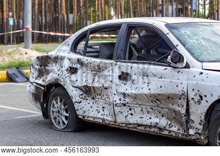 Shot, Damaged Cars During The War In Ukraine. The Vehicle Of Civilians Affected By The Hands Of The