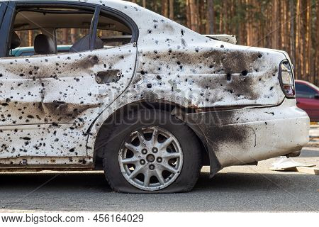 Shot, Damaged Cars During The War In Ukraine. The Vehicle Of Civilians Affected By The Hands Of The