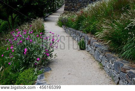 Road Cut Into The Slope. Above And Below The Road Is A Stone Dry Wall. Nature Trail Through The Autu