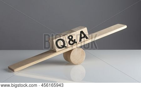 Q And A On Wooden Cubes On A Wooden Balance , Business Concept