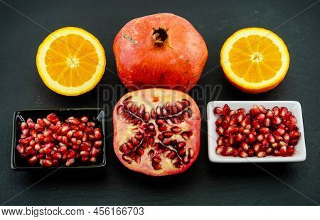 Sliced Red Pomegranate On A Black Slate