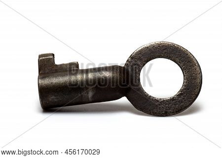 Close Up Of Old Rusty Retro Vintage Small Key For U-locks Shackle Against White Background