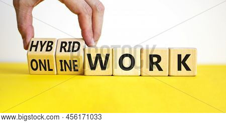 Hybrid Or Online Work Symbol. Businessman Turns Cubes And Changes Words 'online Work' To 'hybrid Wor