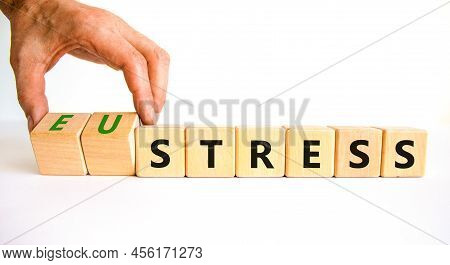 Eustress Or Stress Symbol. Psychologist Turns Cubes And Changes The Concept Word Eustress To Stress.