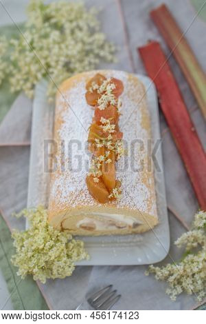 Sweet Home Made Bisuit Roll With Rhubarb And Elderflower On A Table