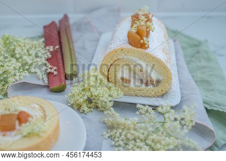 Sweet Home Made Bisuit Roll With Rhubarb And Elderflower On A Table