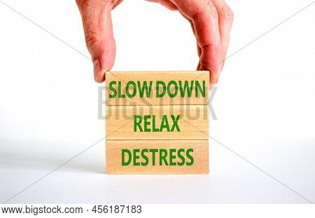 Destress Symbol. Concept Words Slow Down Relax Destress On Wooden Blocks. Beautiful White Table Whit