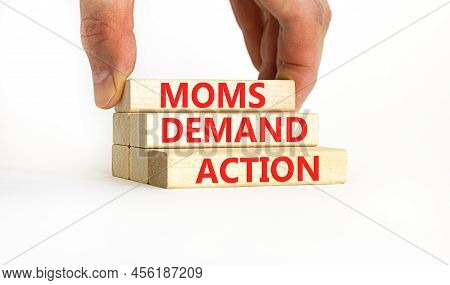 Moms Demand Action Symbol. Concept Words Moms Demand Action On Wooden Blocks On A Beautiful White Ta