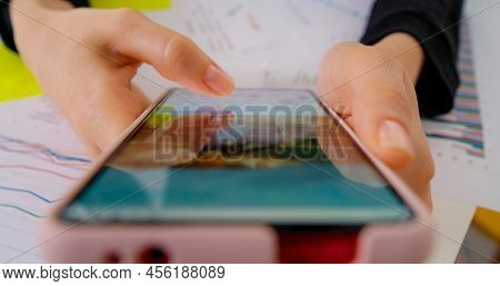 Person Using Smartphone, Browsing Through Pictures On Social Network. Close-up Macro. Finger Scrolli