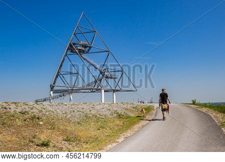 Bottrop, Germany - May 09, 2022: Man Walking His Dog Up The Hill Of The Tetrahedron In Bottrop, Germ