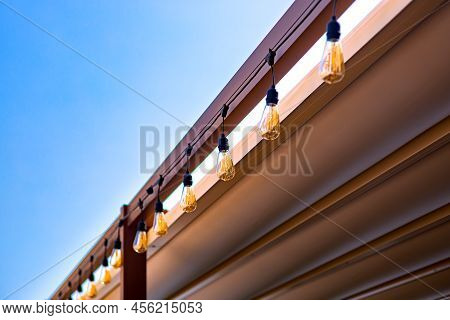 Textile Awning In Backyard Wooden Frame Gazebo With Garland Of Strings Of Retro Edison Light Bulbs G