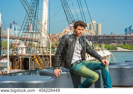 European Businessman Traveling In New York. Wearing Black Leather Jacket, Blue Jeans, A Young Guy Wi