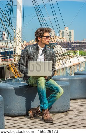 European Businessman Traveling, Working In New York. Wearing Black Leather Jacket, Blue Jeans, Brown