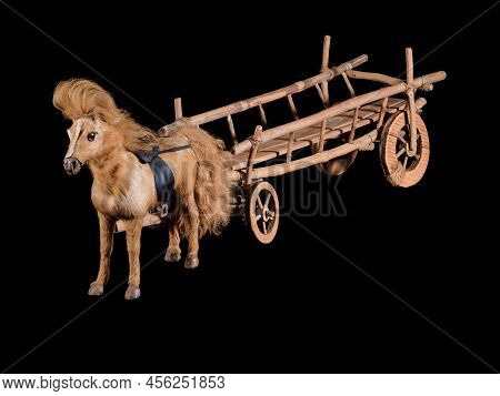 Vintage wooden cart model with horse isolated on black background