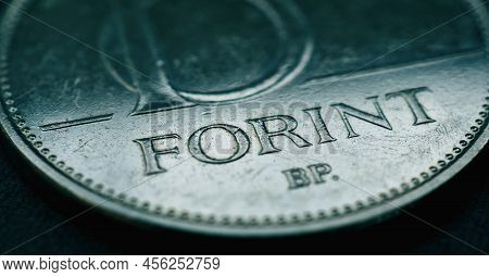 Hungarian Coin Of 10 Forints Lies On A Dark Surface. Money Of Hungary. News About Economy Or Finance