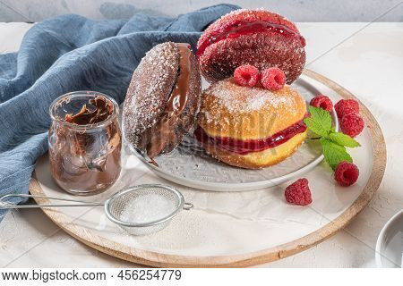 Bolas De Berlim, Or Berlin Balls. Portuguese Fried Dough With Sugar, Filled With Chocolate Or Raspbe