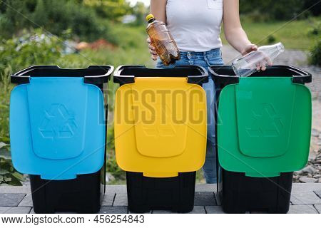 Middle Selection Of Female Hold Two Different Bottle, Plastic And Glass And Thowing Into Different R