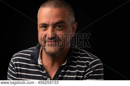 Smiling Man With One Eyebrow Raised Looking Forward