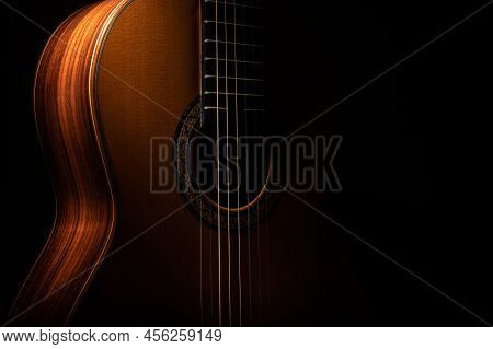 Low Key Classical Guitar On A Black Background With Copy Space