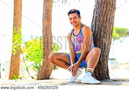 Handsome Man In Colorful Shirt With Rainbow White Socks And Choes Looking At Camera And Smile In Par