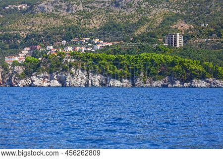 Houses Situated At The Rocky Coast . Coastline Mountains And Blue Sea