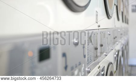 Row Of Washing And Drying Machines, Public Coin Laundry In California, Usa. Drums Of Washers And Dry