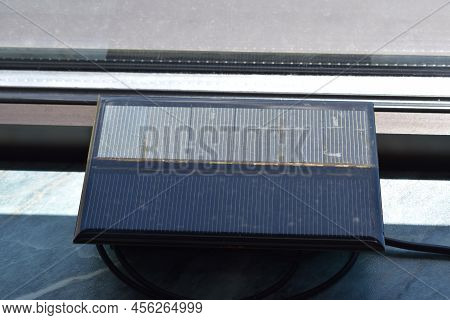 Solar Power Charger For Mobile Devices, Used At A Window
