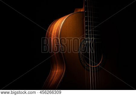 Classical Guitar Up Close On A Black Background With Negative Space For Copy