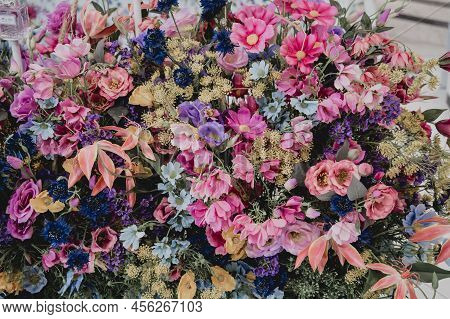 Big Bouquet Of Flowers In A Vase On A Gray Wall Background