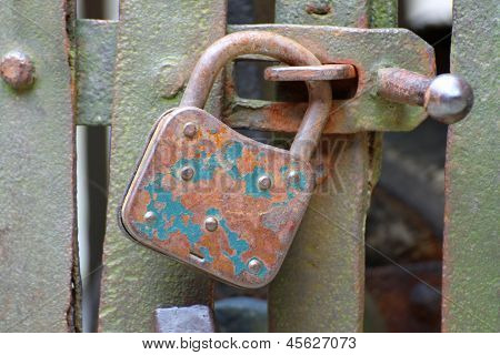 Old Rusty Padlock That Closes The Scratch Of An Ancient Prison Of Bandits