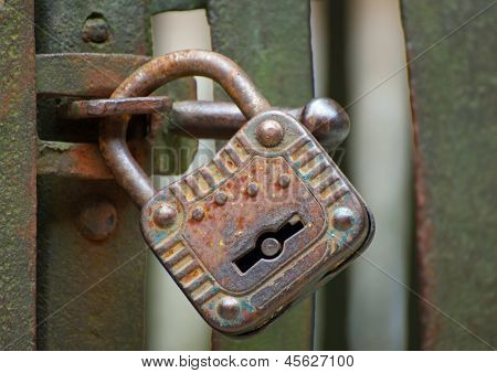 Old Rusty Padlock That Closes The Scratch Of An Ancient Prison Of Bandits