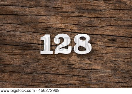 Number 128 In Wood, Isolated On Rustic Background