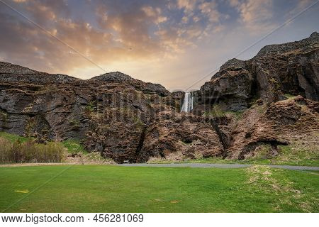 Scenic View Of Gljufrafoss Amidst Mountains In Valley Against Sky At Sunset