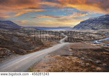 View Of Road Amidst Volcanic Landscape At Eastfjords Against Dramatic Sky