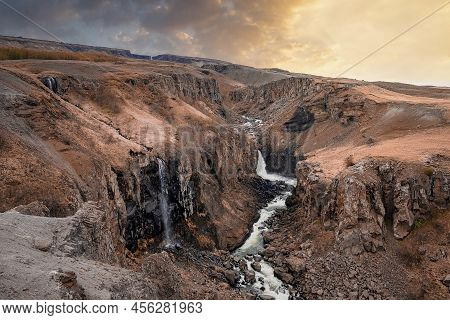 Idyllic View Of Litlanesfoss Waterfall In Eastfjords Against Sky During Sunset