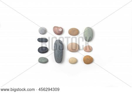 Top View On Arrangement Of Pebbles Of Different Colors And Sizes On White Background